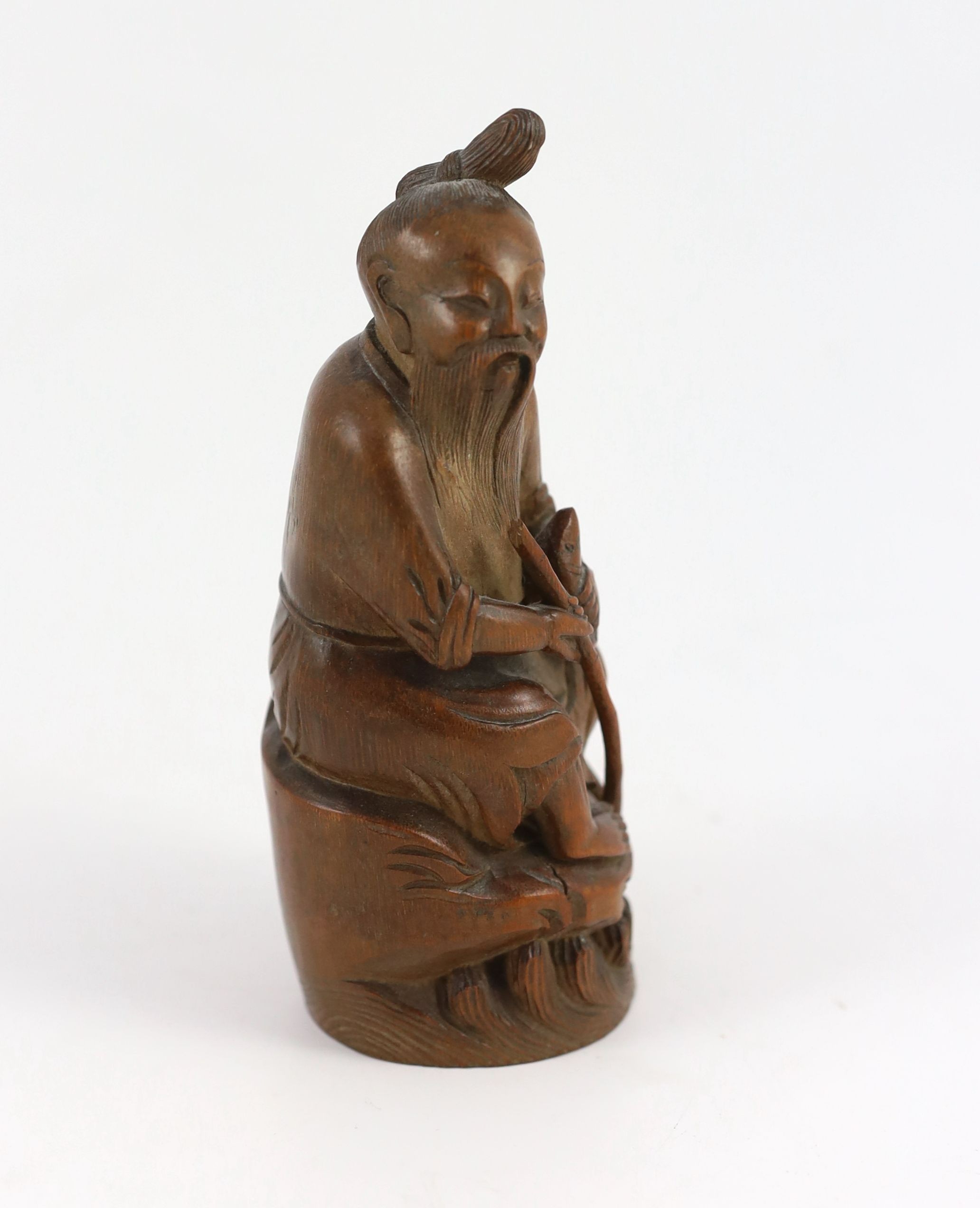 A Chinese bamboo figure of a seated fisherman, 19th century, 16.5 cm high